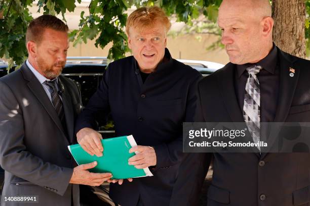 Former Overstock CEO Patrick Byrne is surrounded by private security as he arrives at the Thomas P. O'Neill Jr. House Office Building to be...