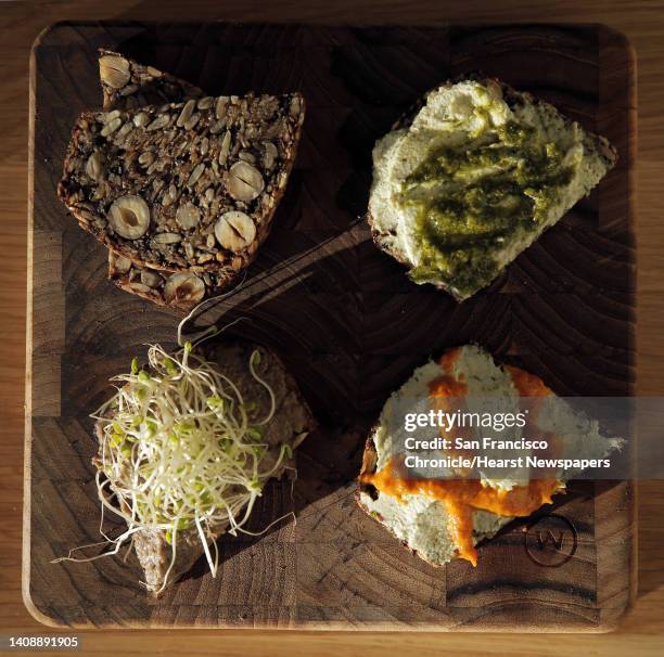 The Sprouted S+S nut loaf served with cashew dill cream cheese, mushroom pate, chimichurri, and sun-dried tomato harissa at Seed + Salt in San...