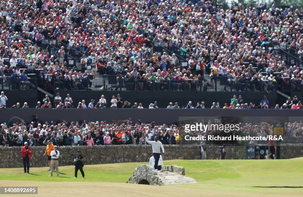 Tiger Woods of the United States acknowledges the crowd on the Swilcan Bridge on the 18th hole during Day Two of The 150th Open at St Andrews Old...