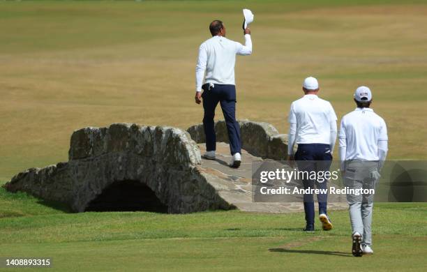 Tiger Woods of the United States acknowledges the crowd as he crosses the Swilcan Bridge during Day Two of The 150th Open at St Andrews Old Course on...