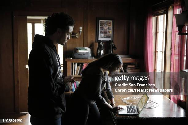 Blake Simons, left, and Cori McGowens, right, look up some information before six members of the demands committee, part of the Black Student Union...