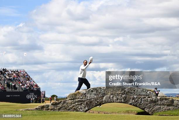 Tiger Woods of the United States acknowledges the crowd on the Swilcan Bridge on the 18th hole during Day Two of The 150th Open at St Andrews Old...