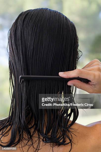 woman combing hair, rear view - nasses haar stock-fotos und bilder