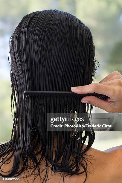 woman combing hair, rear view - wet hair fotografías e imágenes de stock