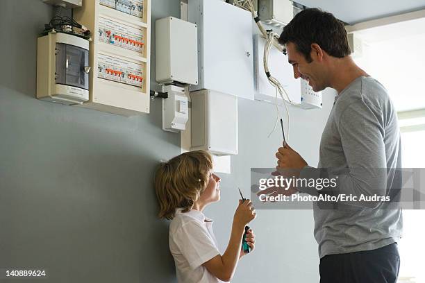 son helping father with home improvement - fuse box ストックフォトと画像