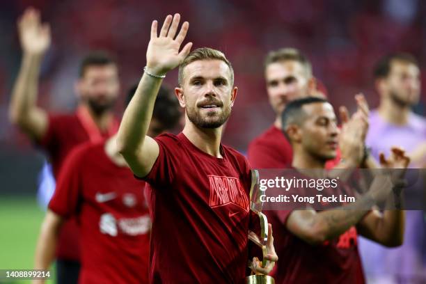 Jordan Henderson of Liverpool celebrates with the match trophy after defeating Crystal Palace 2-0 during their preseason friendly at the National...