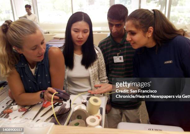 Students attending Stanford's Youth Medicine and Science Clinic, watch as physical therapist, Anna Bailey, left, demonstrates a new biofeedback...