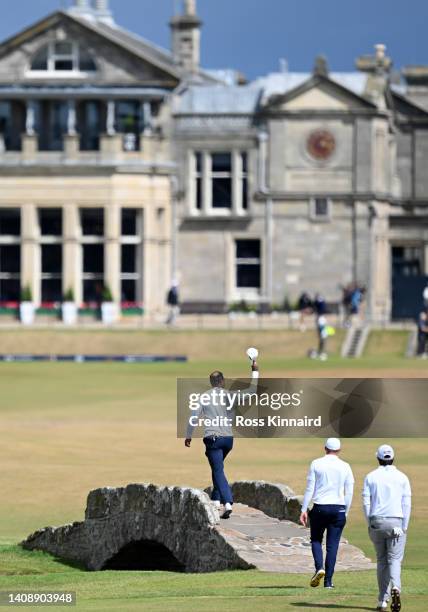 Tiger Woods of the United States acknowledges the crowd as he crosses the Swilcan Bridge during Day Two of The 150th Open at St Andrews Old Course on...