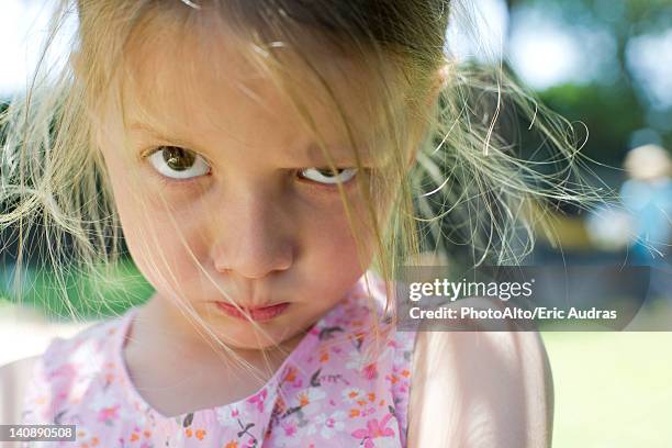 little girl staring at camera with lips pursed - puckering 個照片及圖片檔