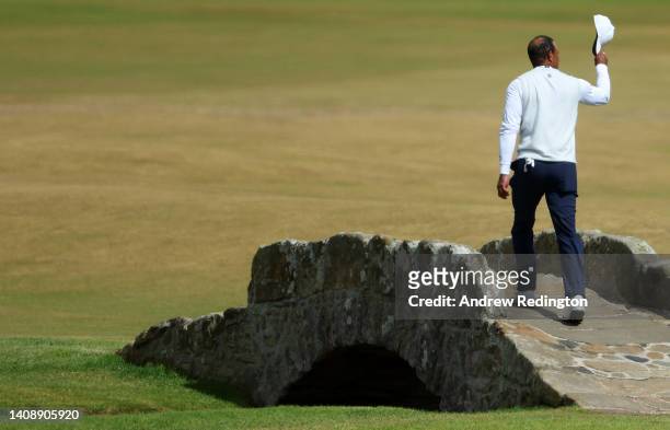 Tiger Woods of the United States acknowledges the crowd as he crosses the Swilcan Bridge during Day Two of The 150th Open at St Andrews Old Course on...