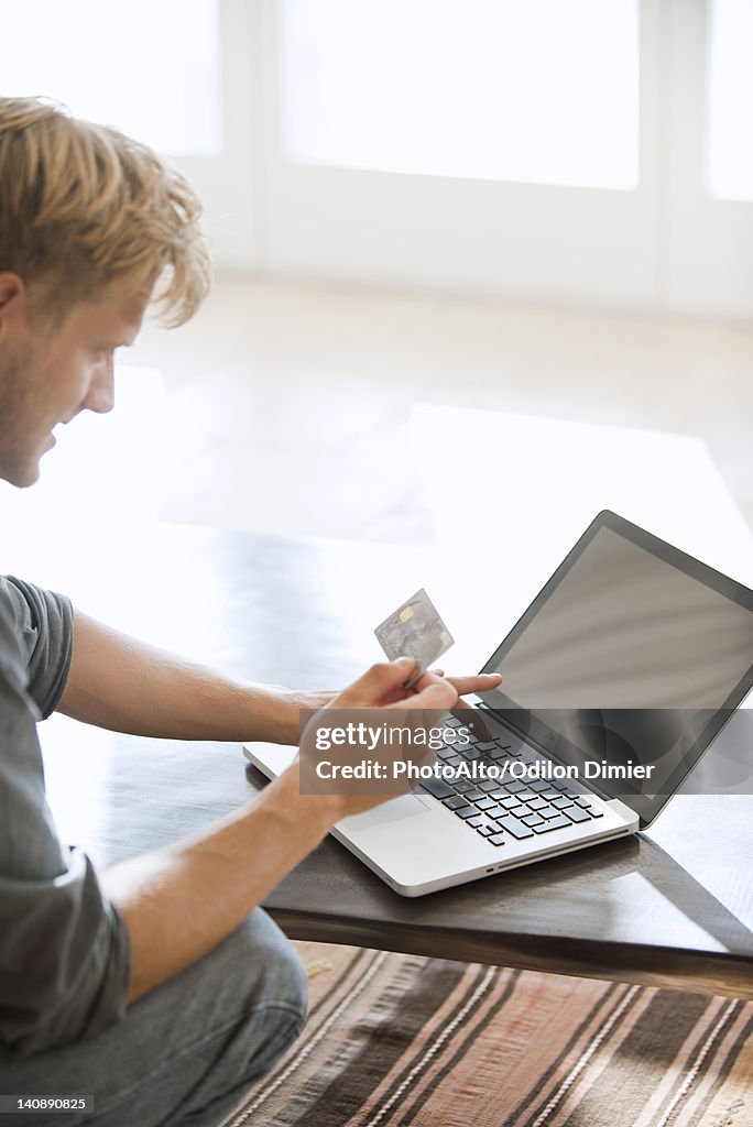 Man using credit card to make an online purchase