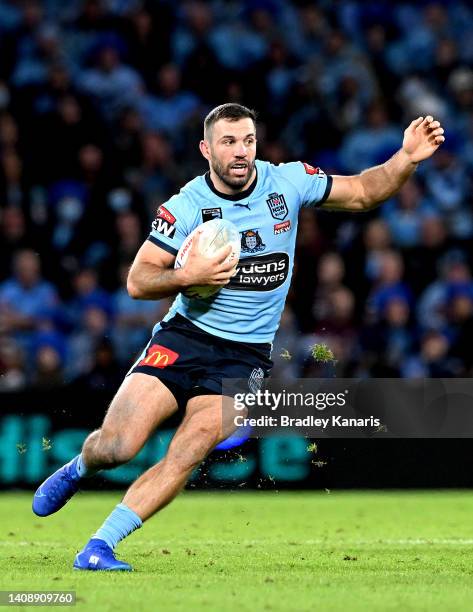 James Tedesco of the Blues runs with the ball during game three of the State of Origin Series between the Queensland Maroons and the New South Wales...