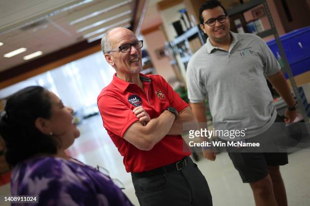 Maryland Democratic gubernatorial candidate Tom Perez helps talks with staff members at the Upcountry Food Hub on July 15, 2022 in Germantown,...