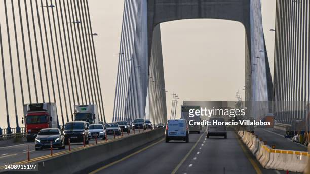 Cars and trucks drive across Vasco Da Gama Bridge in the early morning on July 15 in Lisbon, Portugal. The Vasco da Gama Bridge is a cable-stayed...