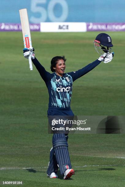 Sophia Dunkley of England raises their helmet and bat as they celebrate after reaching a century during the 2nd Royal London Series One Day...