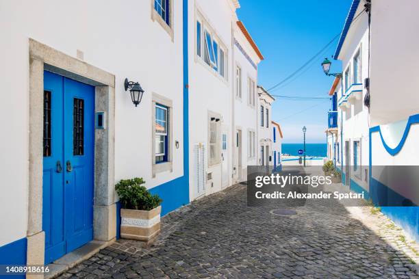 street in ericeira town on a sunny day, portugal - portugal stock-fotos und bilder