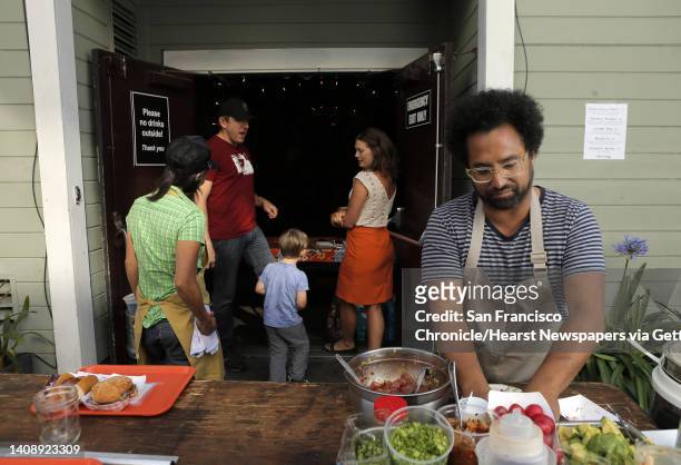 Chef Ravi Kapur prepares Hawaiian dishes as his wife, April Storm, rear right, tends to friends Ned Buskirk and Shay and assistant chef Nana Guardia,...