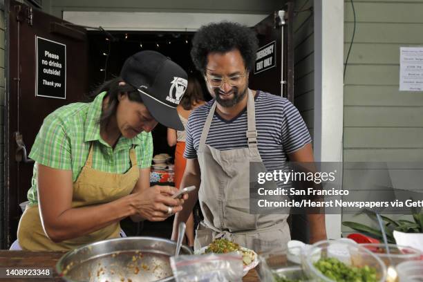 Chef Ravi Kapur, right, watches as assistant chef Nana Guardia photographs a poke dish during Kapur's restaurant pop up called Paniolo Social Club at...