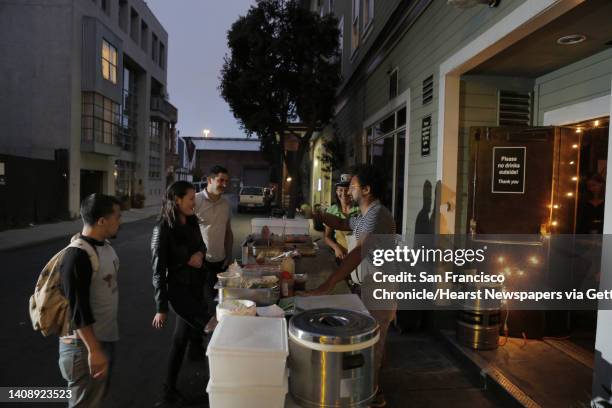 Chef Ravi Kapur, center, talks with customers at his pop up restaurant at Bloodhound Bar on Thursday. Kapur is holding a restaurant pop up called...