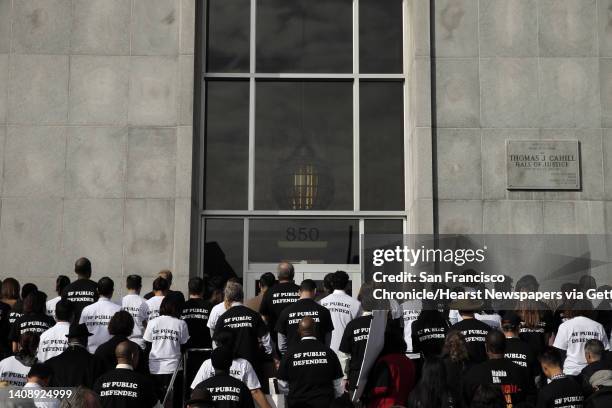 San Francisco Public Defender Jeff Adachi and several lawyers from his office, along with supportive attorneys, have a moment of silence as they held...