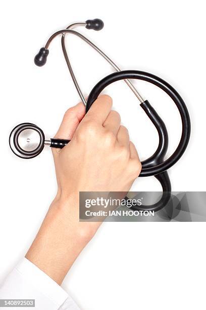 stethoscope - doctor gripping stock pictures, royalty-free photos & images