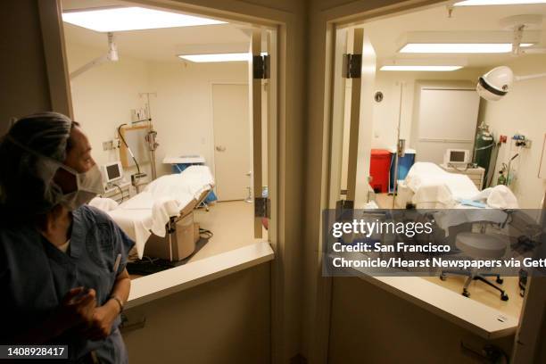 Dr. Shehua Shen, director of the UCSF embryology lab, stands next to two of the rooms used to collect ova from donors and women seeking in vitro...