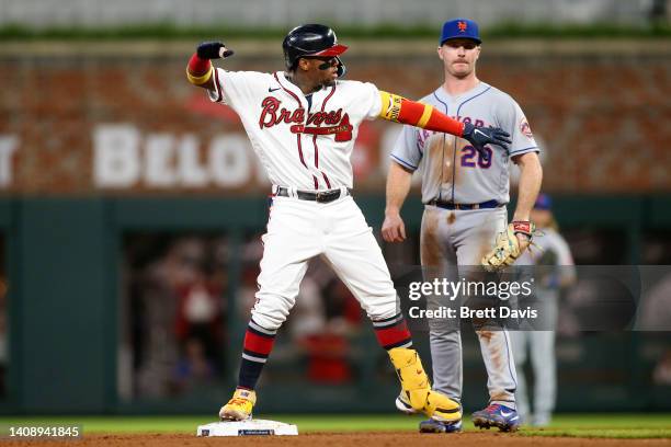 Ronald Acuna Jr. #13 of the Atlanta Braves celebrates after a double against the New York Mets in the eighth inning at Truist Park on July 11, 2022...