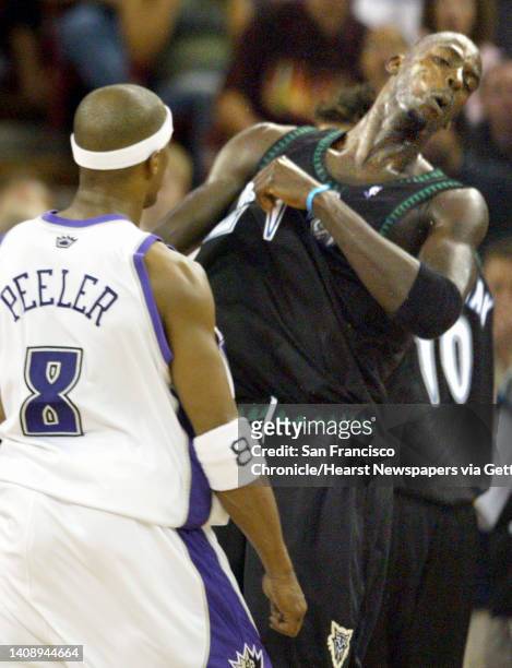 Milwaukee Timberwolves Kevin Garnett reacts to a blow from Sacramento Kings guard Anthony Peeler connects within the third quarter of Game 6 of their...