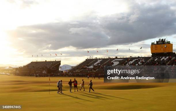 General view on the 18th green as Rory McIlroy of Northern Ireland, Collin Morikawa and Xander Schauffele of the United States shake hands during Day...