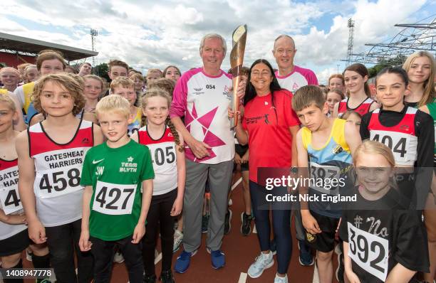 Batonbearer Sir Brendan Foster, Olympian Angela Gilmour, batonbearer Ian Goulding, and children from local athletic clubs during the Birmingham 2022...