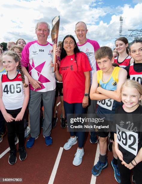 Batonbearer Sir Brendan Foster, Olympian Angela Gilmour, batonbearer Ian Goulding, and children from local athletic clubs during the Birmingham 2022...