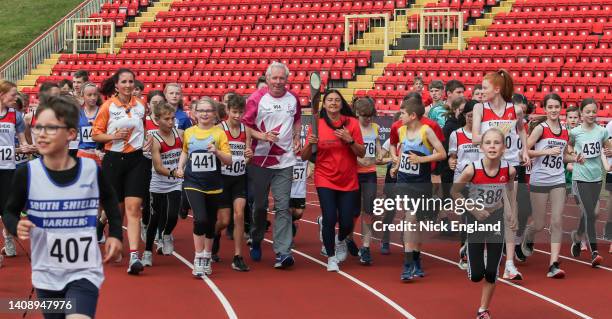 Batonbearer Sir Brendan Foster and Olympian Angela Gilmour with children from local athletic clubs during the Birmingham 2022 Queen's Baton Relay on...