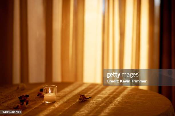 golden hour table with leaves and votive - goldene stunde stock-fotos und bilder