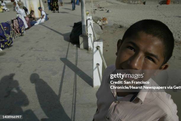 Roberto Carlos Montes Cantor is 14 and homeless. He spends his days fishing off the pier at Playa De Los Muertos with a fishing line tied around an...