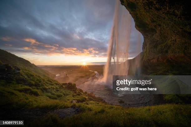 seljalandfoss waterfall in summer time at sunset, iceland - セリャランスフォス ストックフォトと画像