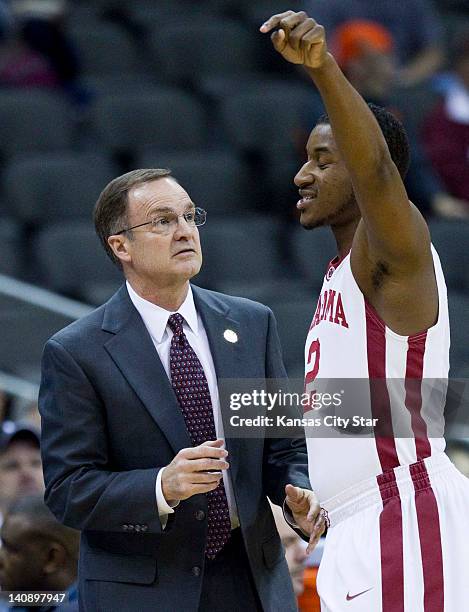 Oklahoma head basketball coach Lon Kruger listened as Oklahoma Sooners guard Steven Pledger talked about the game in the first half of the Big 12...