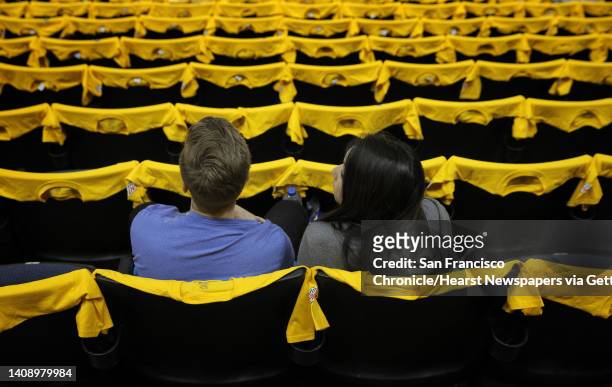 Jarret and Annette Kasper surrounded by Warriors t-shirts in the stands while waiting for the Golden State Warriors to play the Portland Trail...