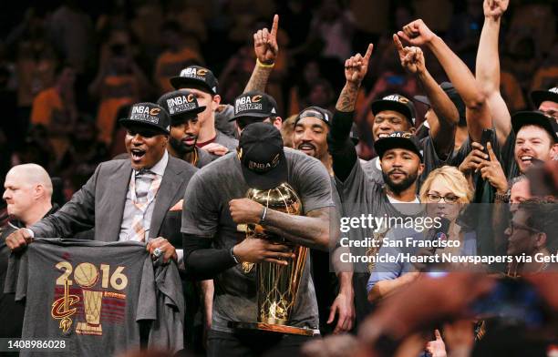 Tearful Cleveland Cavaliers' LeBron James hugs the Larry O’Brien NBA Championship Trophy after the Cavaliers defeated the Golden State Warriors, 93...