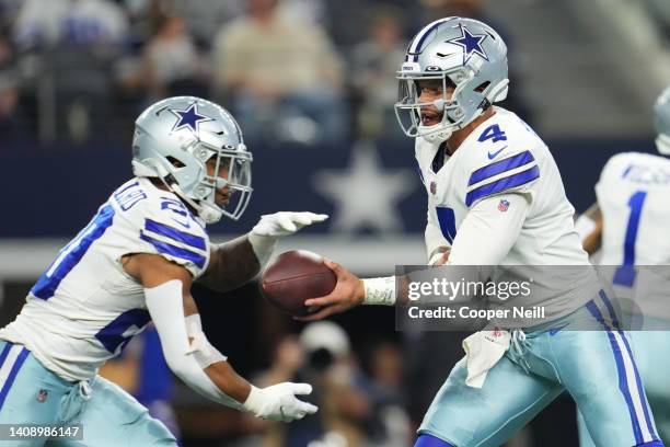 Dak Prescott of the Dallas Cowboys hands the ball off to running back Tony Pollard against the Las Vegas Raiders during an NFL game at AT&T Stadium...