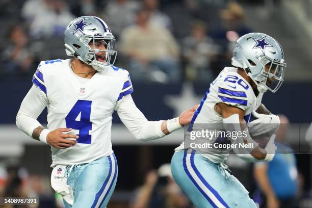 Dak Prescott of the Dallas Cowboys hands the ball off to running back Tony Pollard against the Las Vegas Raiders during an NFL game at AT&T Stadium...