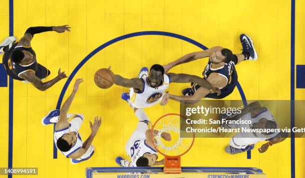Draymond Green reaches for a rebound on a shot by Rudy Gobert in the second half as the Golden State Warriors played the Utah Jazz at Oracle Arena in...