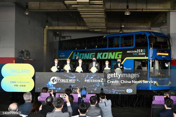 People attend the unveiling ceremony of Hong Kong's first electric tri-axle double-decker bus powered by hydrogen fuel cell and battery, which was...