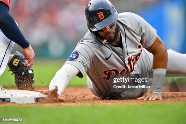 Willi Castro of the Detroit Tigers dives back to first base on a pickoff attempt during the fourth inning against the Cleveland Guardians at...