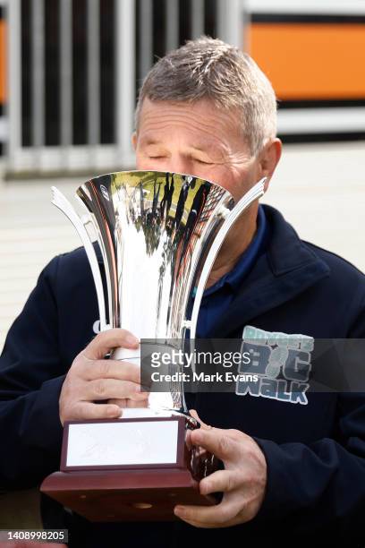 Royce Simmons pretends to drink out of the Royce Simmons cup during a Wests Tigers NRL media opportunity at Cintra park on July 16, 2022 in Sydney,...
