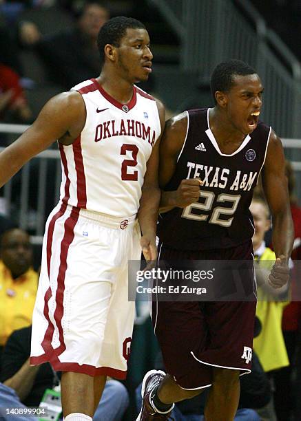 Khris Middleton of the Texas A&M Aggies celebrates a three point shot against Steven Pledger of the Oklahoma Sooners during the first round of the...