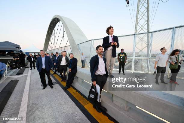Boy and his father stand by the side of the bridge and watch the stage during the opening of the new 6th Street Bridge on July 08, 2022 in Los...