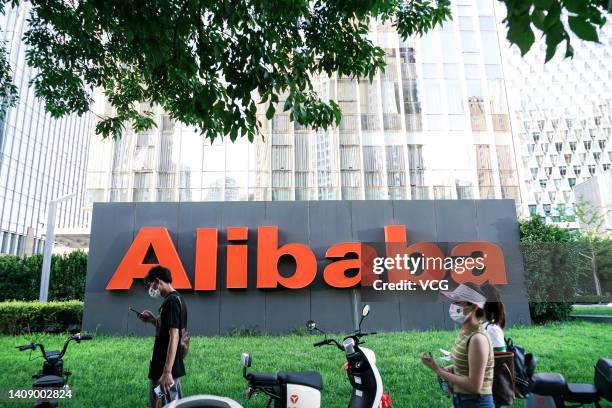 Pedestrian walks past Alibaba Group Holdings Ltd. Signage displayed outside the company's offices on July 14, 2022 in Beijing, China.