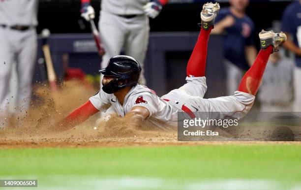 Xander Bogaerts of the Boston Red Sox scores on a wild pitch in the 11th inning at Yankee Stadium on July 15, 2022 in the Bronx borough of New York...