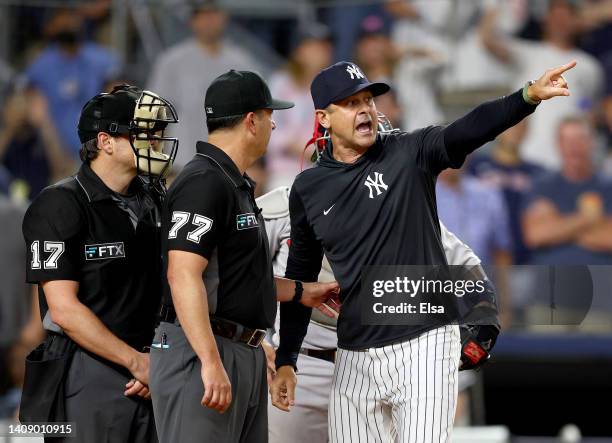 Manager Aaron Boone of the New York Yankees yells at home plate umpire D.J.Reyburn after Boone was tossed from the game in the ninth inning against...