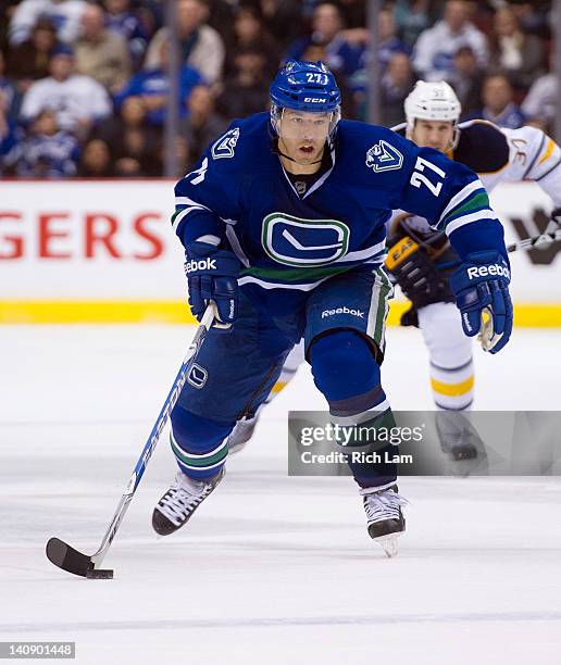 Manny Malhotra of the Vancouver Canucks skates with the puck during NHL action against the Buffalo Sabres on March 03, 2012 at Rogers Arena in...